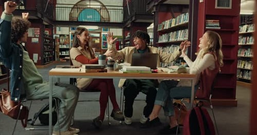 High five, study group and students in library with textbooks preparing for university exam