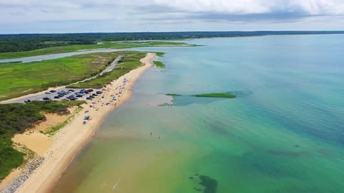 Beach Houses, Cars, and Boat Offshore on Scenic Summer Shoreline
