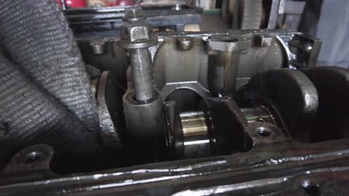 Close Up of Mechanic Repairing Dirty Engine