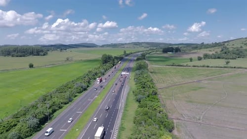 Highway road traffic flow with cars and trucks aerial view in green rural landscape