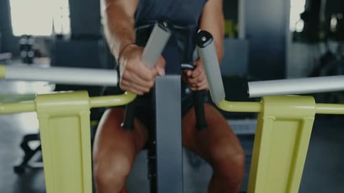 Man Exercising on Machine in Gym for Strength and Fitness Training