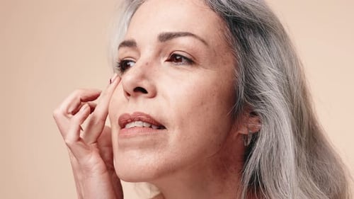 Mature Woman Applies Beauty Cream, Close Up