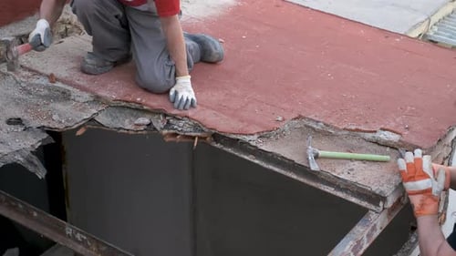 Construction Workers Renovating a Rooftop in Urban Setting