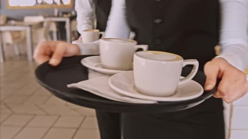 Waitstaff Carrying Coffee Drinks in Restaurant Setting