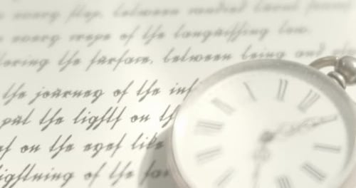 Vintage Pocket Watch Lying on a Written Document