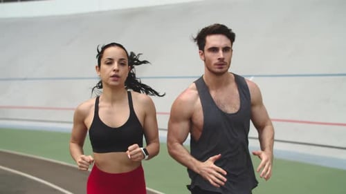 Fitness Couple Running on Athletics Track. Sport Couple Training Together at Sport