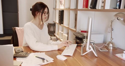 Young Business Woman in Glasses Working in Office Interior on Pc on Desk Typing