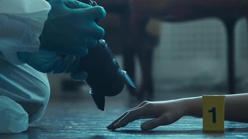 Hand at Crime Scene with Evidence Marker