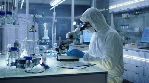 Scientist in Protective Suit Working in Laboratory