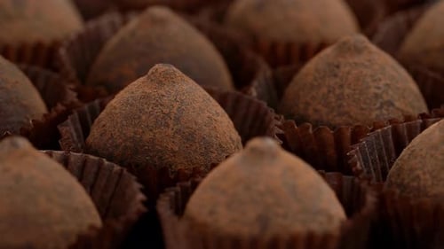 Close Up of Truffle Chocolate Candies Rotate in Circle Food Dessert Background