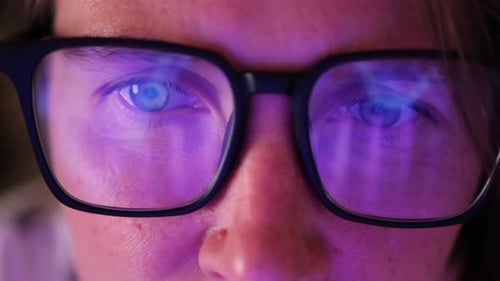Close Up of Face With Light Reflecting in Glasses