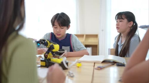 Children Studying Robotics in a Bright Classroom