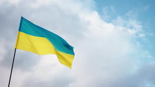 Waving Flag Against Sky with Clouds