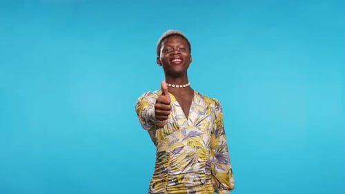 Glad Black Non Binary Person Gesturing Thumb Up
