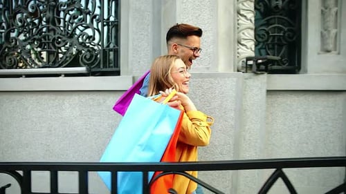 Young couple walking in and city enjoying in shopping together.