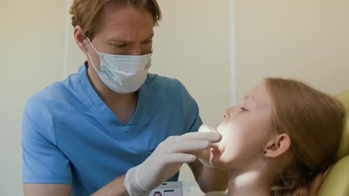 Pediatric Dentist Performing Oral Exam