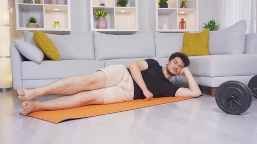Man Doing Leg Lifts in Living Room