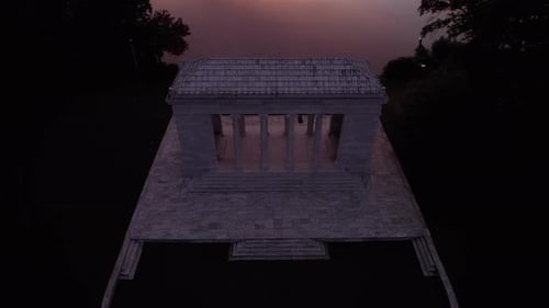 Aerial view of a sunset over the Roger Williams Park music temple and the lake in the background.