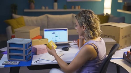 Woman Working from Home Inspecting Merchandise