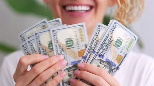 Excited Smiling Woman Showing Cash Money 1000 American Dollars Banknotes Hands with Money Close Up
