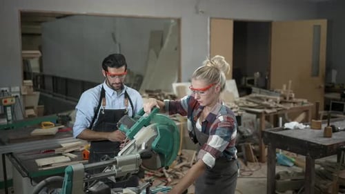 Carpenters are working together at workshop.