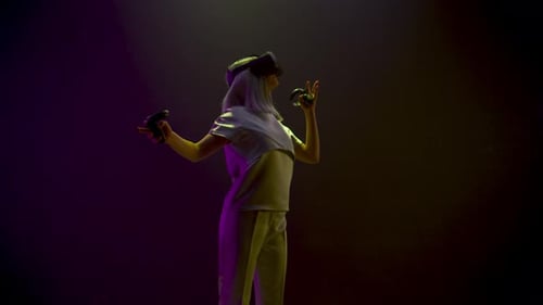 Woman in VR headset using controllers