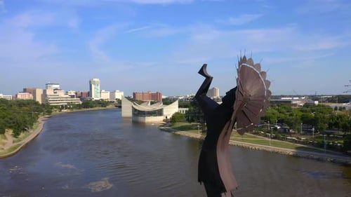 Aerial shot of metal sculpture river cityscape skyline
