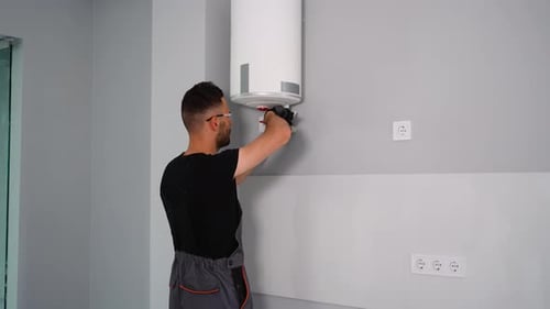 Heating Installation Technician Settings the Boiler