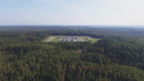 Aerial Flying Towards Factory Area In The Middle Of A Coniferous Forest.