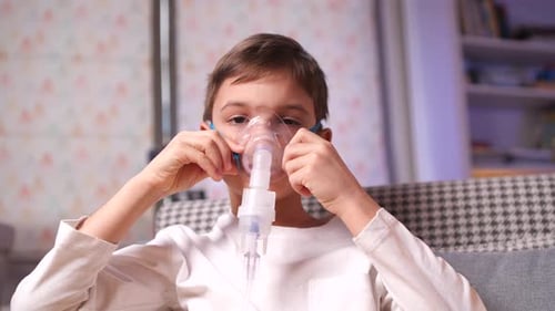 Child Using Nebulizer for Respiratory Treatment at Home