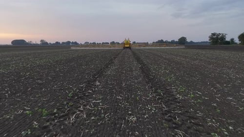 Tractor Spraying Pesticides On agricultural field With Sprayer