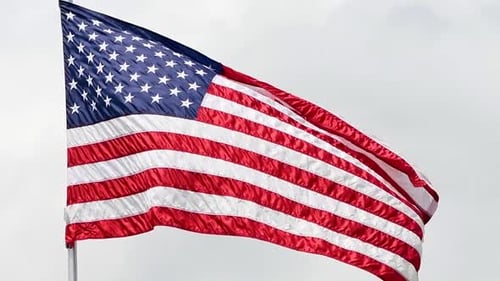 American Flag waving on a flagpole, daytime