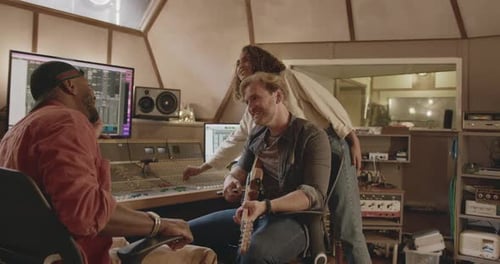 Band Composing with Producer in Music Recording Studio