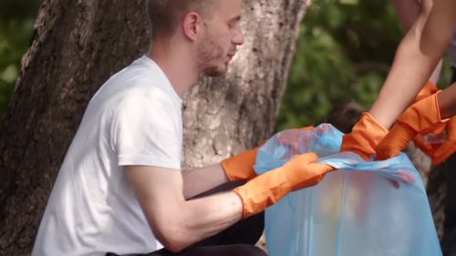 Young Adults Cleaning Up Trash in Urban Park