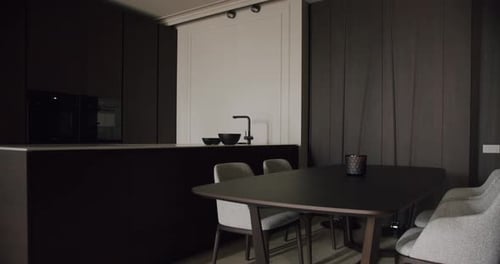 Modern Minimalist Kitchen Dining Area With Dark Cabinets And Dining Table