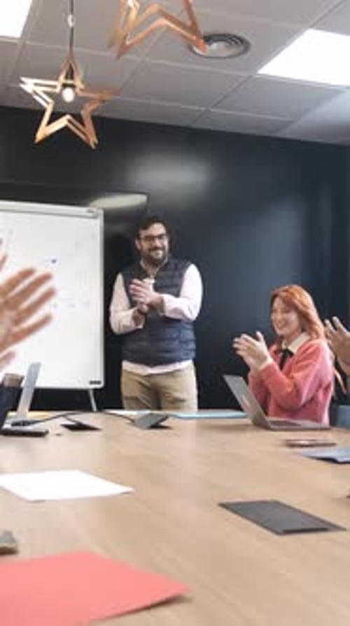 Man Presents to Colleagues in a Bright Workplace
