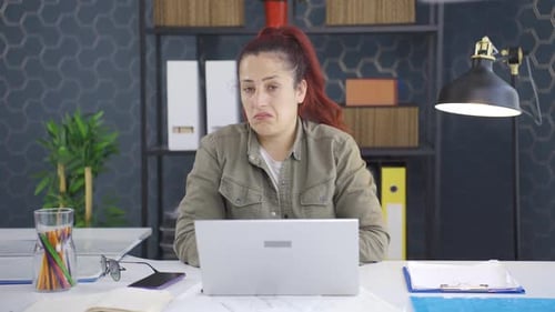 Woman Thinking at Desk in Office