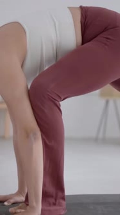 Young Woman in Comfortable Sportswear Leggings and Top Practising Yoga in Modern Studio