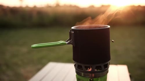 Pot of Steaming Food Camping at Sunset
