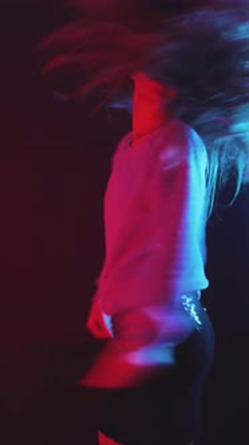 Woman Dancing in place under red and blue lights