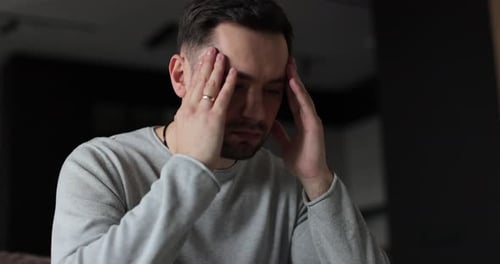 Young Man Tired with Hands on Face Physical and Emotional Discomfort of Pressure and Stress Human