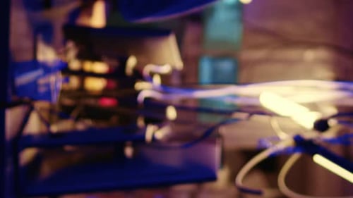 Hooded Figure Hacking at Computer Workstation at Night