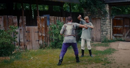 Men in Armor Sword Fighting in Rural Setting