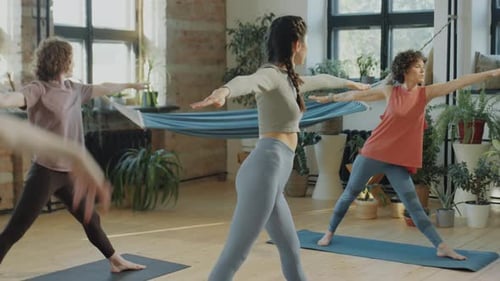 Women Practicing in Yoga Studio