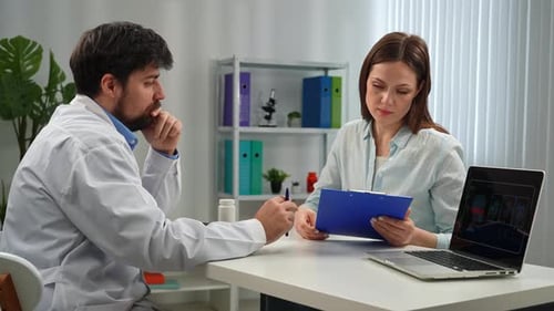 Doctor and Patient Discussing Medical Diagnosis in Office