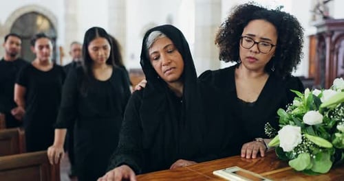 Coffin, funeral and sad family with death, mourning or burial ceremony in church with flowers