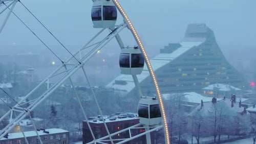 Aerial View of Ferris Wheel in Snowy Winter City