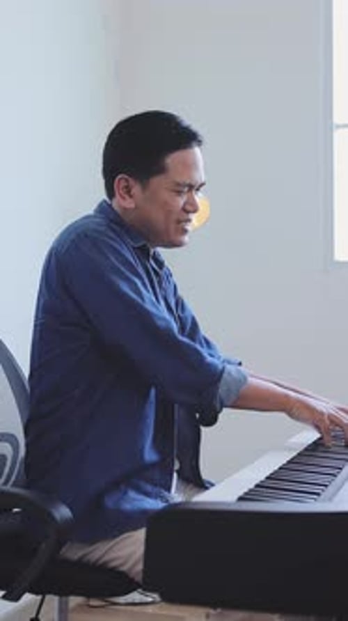 Man Plays Keyboard in Home