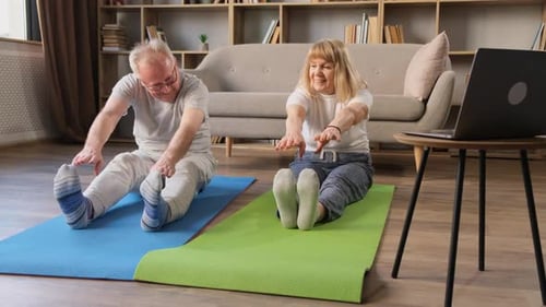 Active Senior Couple Stretching Together at Home