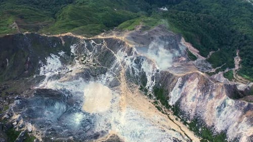 Aerial view above dramatic crater lake in stratovolcano Mount Sibayak in North Sumatra, Indonesia